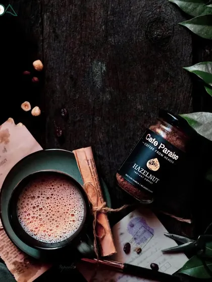 My first professional project. This dark, rustic flat lay for a coffee brand uses vintage props like old letters and a quill to tell a story of heritage and passion.