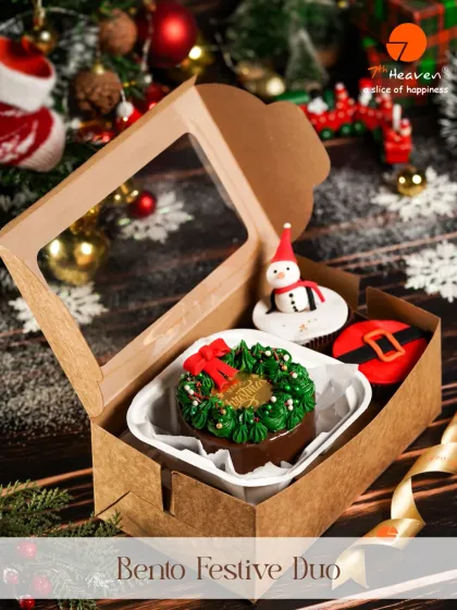 A little box of Christmas cheer. Our Bento Festive Duo includes a mini wreath cake and adorable cupcakes decorated like a snowman and Santa's belt.