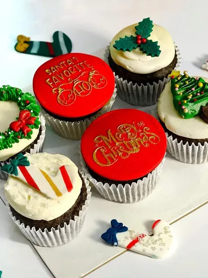 My Christmas cupcake collection! I had so much fun designing these, with themes like wreaths, candy canes, and Santa's favorite treats.