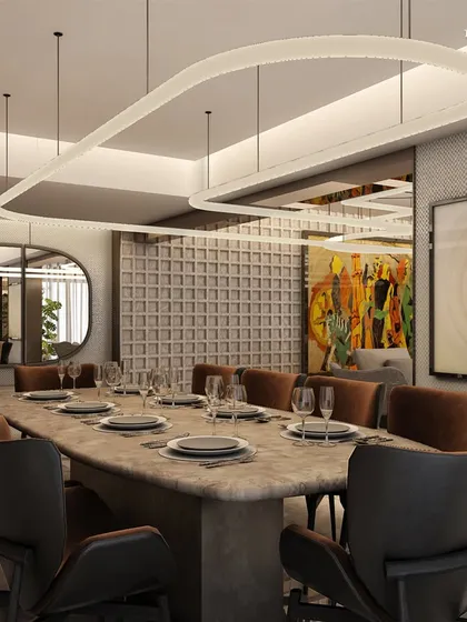 This dining room in a multi-story family home on Carter Road is a celebration of artisanal excellence. The use of natural stone and a textured wall brings a sense of timeless sophistication, while a large abstract light fixture adds a modern, dramatic touch.