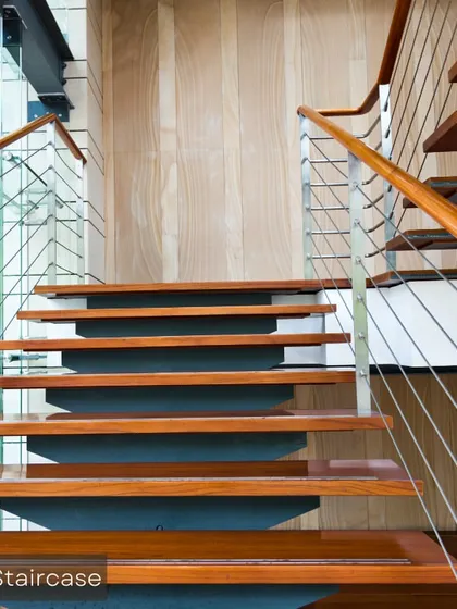 We also design and execute structural elements like this beautiful wooden staircase with a glass and steel railing, adding a touch of modern elegance to a home.