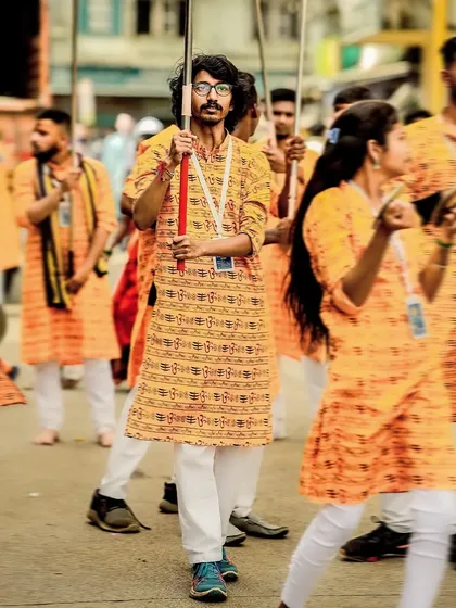 The photographer himself, captured as a flag bearer in the procession.