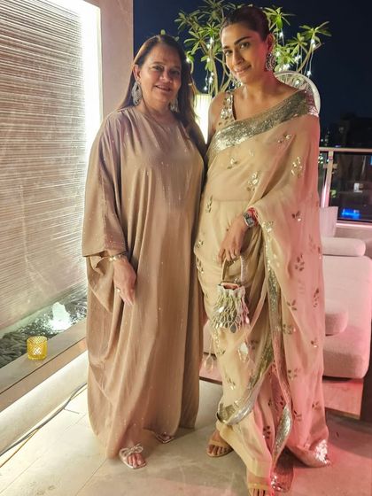 A lovely moment with my mom. I'm wearing a sequined Sabyasachi saree, which is my go-to for adding some sparkle to a wedding celebration.