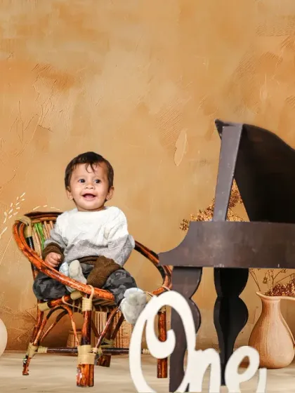 A rustic, boho-themed first birthday shoot. The neutral tones and natural textures create a warm and timeless look.