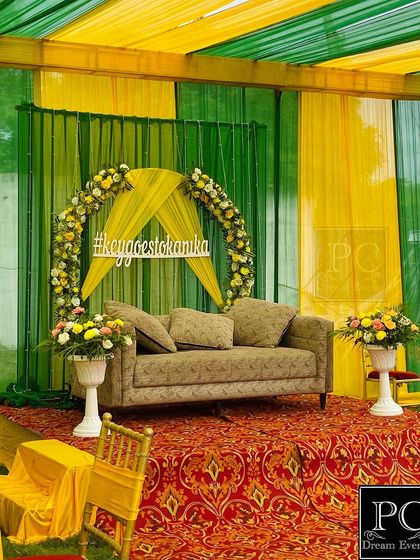 A close-up of the main stage, highlighting the custom hashtag and the simple elegance of the floral decor against the draped background.