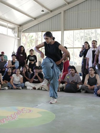 A dancer commands the floor during a battle at Spectra. The crowd's energy fuels the performers, creating an unforgettable atmosphere of support and competition.