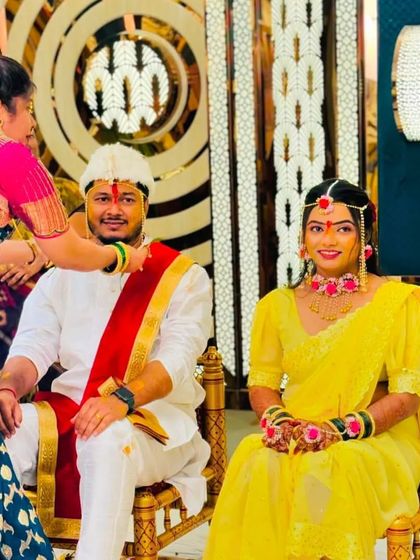 A happy moment from a Maharashtrian Haldi ceremony at the Grand Utsav banquet. The couple is all smiles, dressed in traditional yellow attire for the ritual.