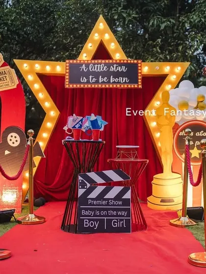 Announcing the arrival of a little star with a 'Lights! Camera! Baby!' themed baby shower. This fun, glamorous setup includes a red carpet entrance, a marquee star, and movie-themed props, making the parents-to-be feel like true celebrities.