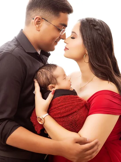 An intimate and artistic shot of the new parents with their baby. This pose creates a beautiful silhouette and emphasizes their connection.