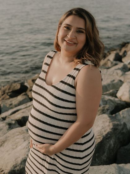 A solo shot of the glowing mom to be. The makeup for this beach maternity shoot was designed to be minimal and fresh, enhancing her natural pregnancy glow.