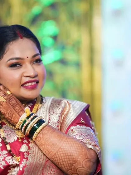The beauty of simplicity for a reception. This bride's happiness is the best accessory, complemented by a clean makeup look and a classic red saree.