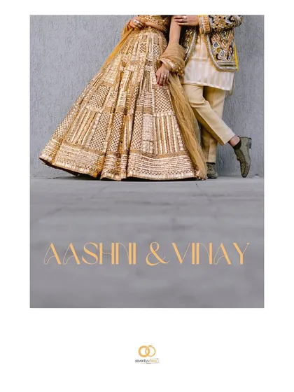 A minimalist, artistic shot focusing on the lower half of their golden outfits. The text overlay turns this detail shot into a beautiful title card for their love story.