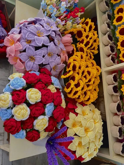 A collection of vibrant, custom-made bouquets featuring roses, lilies, and sunflowers.