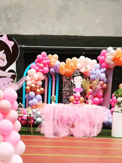 A beautiful Ballerina-themed party with a pink tulle table skirt and graceful ballerina cutouts.