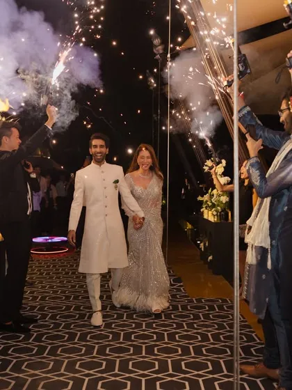 Couple entries should be grand and energetic. For this Sangeet, I planned a sparkling entrance with guests holding cold-pyro guns, creating a tunnel of light for the couple to walk through.