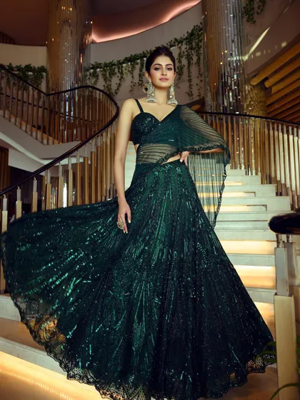 A duplicate of image 30, this full-length shot captures the dramatic flair of the emerald green lehenga styled for Manasa Varanasi's magazine cover shoot.