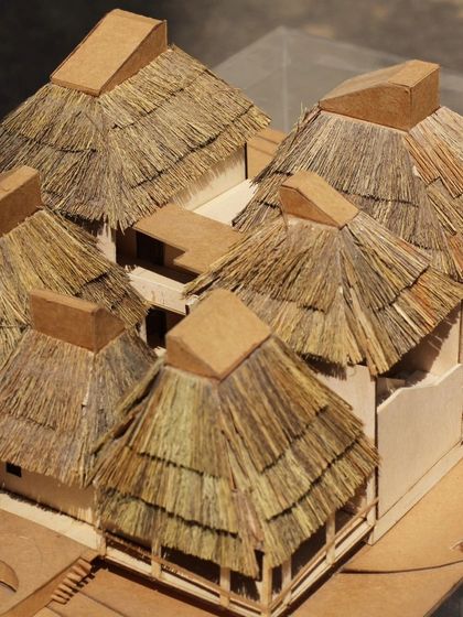 An overhead view of the 'Serenity' model, showing the cluster of thatched-roof cottages. This type of model helps us and our clients visualize the project's overall massing and layout.