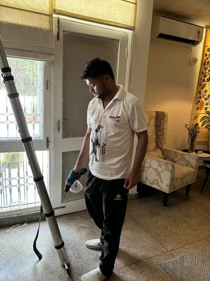 A member of my team with our portable ladder and drill, ready to begin the next phase of an indoor installation. We bring all necessary tools to every site.