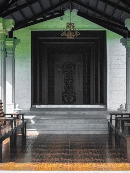 A closer look at the farmhouse entrance, highlighting the intricately carved wooden door and classical columns.