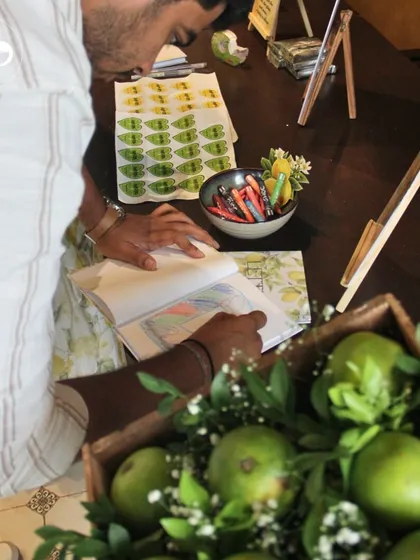 A guest participating in a coloring activity at a baby shower. Providing engaging, low-key activities is a great way to ensure everyone feels included and has a good time.