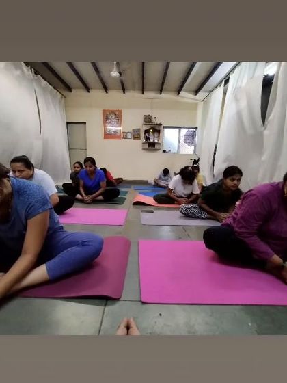 Students in a seated forward bend, Baddha Konasana (Bound Angle Pose). This posture helps release tension in the inner thighs and groin, and we focus on breathing into the stretch.