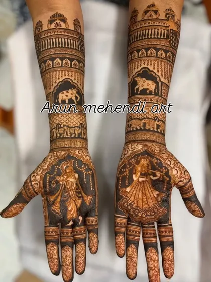 A divine design featuring Radha and Krishna on the palms, with cows and palace architecture on the forearms.