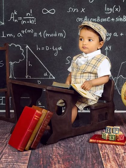 A full view of the "Aariv's Class" setup, with the baby boy looking like a proud student at his desk.