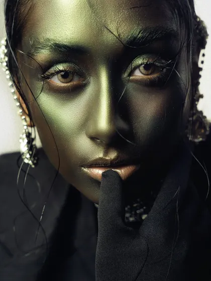 An intense, direct close-up from the 'Chrome' series. The framing is tight, focusing entirely on the eyes and the metallic skin, creating a powerful and slightly unsettling beauty portrait.
