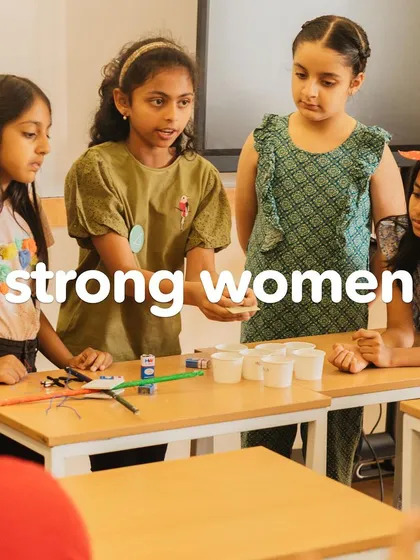 A group of girls collaborates on a science experiment, demonstrating the power of teamwork and shared curiosity. Here's to strong women.