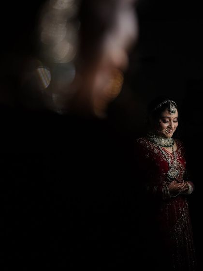 An artistic and moody bridal portrait using creative lighting effects. This low-light shot creates a sense of mystery and elegance.