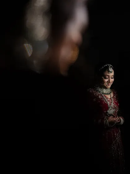 An artistic and moody bridal portrait using creative lighting effects. This low-light shot creates a sense of mystery and elegance.