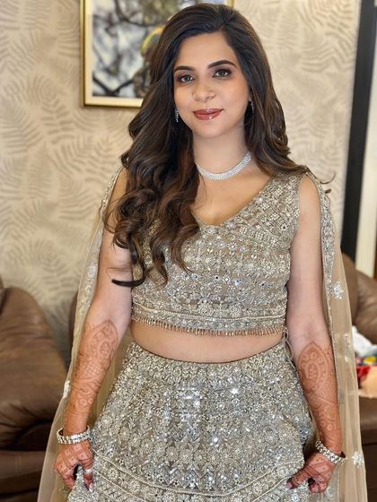 The full look, showcasing the elegant silver lehenga and the complementary soft glam makeup.