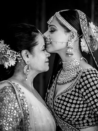 A tender moment between a bride and her mother. This black and white photograph captures the deep emotional bonds that are at the heart of every wedding we plan.