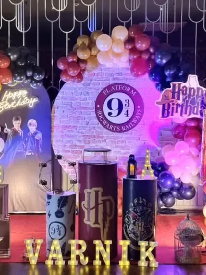 A magical Harry Potter themed birthday party setup. This detailed arrangement includes a "Platform 9 3/4" backdrop, house color balloon garlands, character posters, and iconic props like the Sorting Hat and Hedwig the owl to transport guests to the wizarding world.