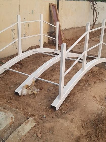 A small arched bridge, fabricated and painted, ready for installation at our school project site. Every custom element, no matter the size, is carefully crafted to fit the overall design narrative.