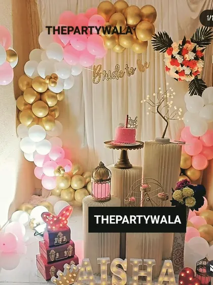 A beautiful "Bride to be" party decoration. The pink, white, and gold balloon arch with a custom banner is a perfect way to celebrate the future bride.
