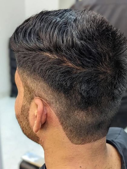 A detailed view of a precision fade. The gradual transition from skin to hair is a testament to our barber's skill and attention to detail.