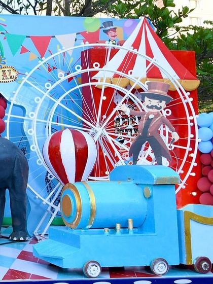 A fun corner of the carnival theme, with a blue train, a Ferris wheel, and an elephant prop.