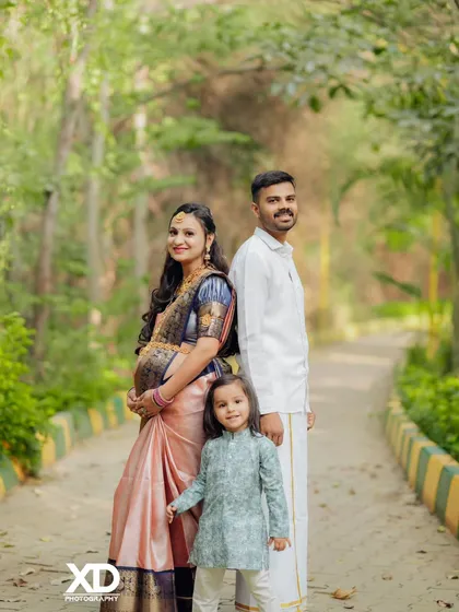 A fun family pose with their first child, capturing a beautiful memory before they become a family of four.