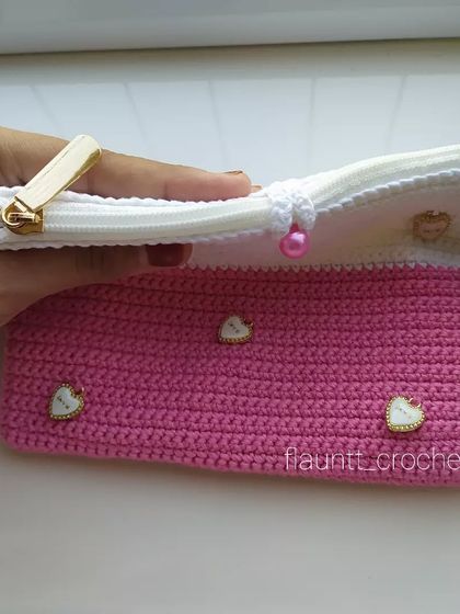 Showing the inside of the custom clutch, which has a zipper and a wristlet strap for easy carrying.