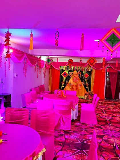 The same pink-themed hall under different lighting, showing how coloured lights can change the mood of the space.