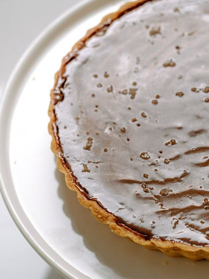 Our signature salted caramel and dark chocolate tart, a perfect centerpiece for a Valentine's Day celebration or any special occasion.