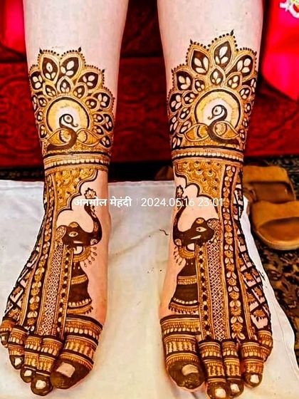 A close-up of intricate foot mehendi, featuring elephant and peacock motifs that perfectly complement a full bridal design.