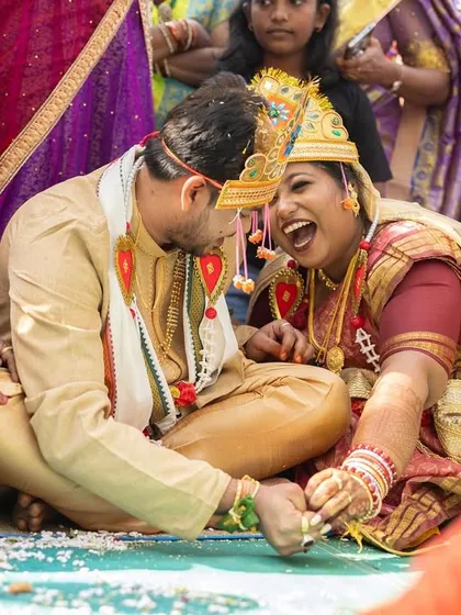 A moment of shared laughter during an Odia wedding ritual. Surrounded by family, the couple finds joy and humor in the traditions, creating a memory that is both sacred and fun.