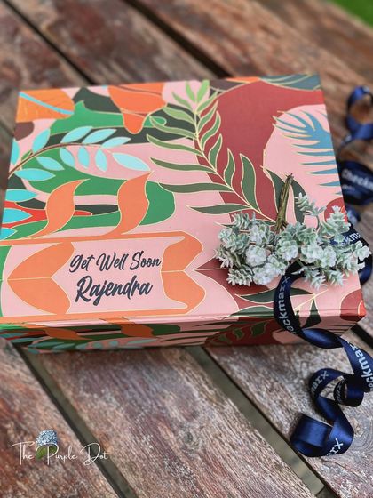 A different style of get well soon gift, this one presented in a vibrant, personalized box.