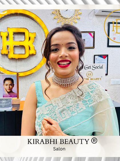 A happy and glowing client showing off her finished party look. The bright red lip and sparkling jewelry are the perfect finishing touches.