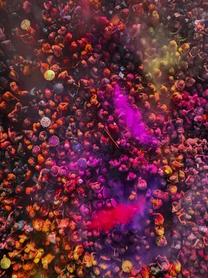 A close-up of the crowd during Holi, a sea of faces and colors. Every person is part of this incredible, moving painting.
