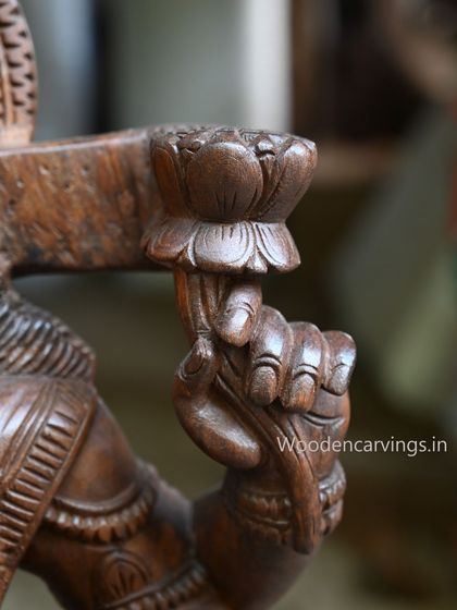 A close-up of one of the hands of the 36-inch MahaLakshmi holding a lotus bud.