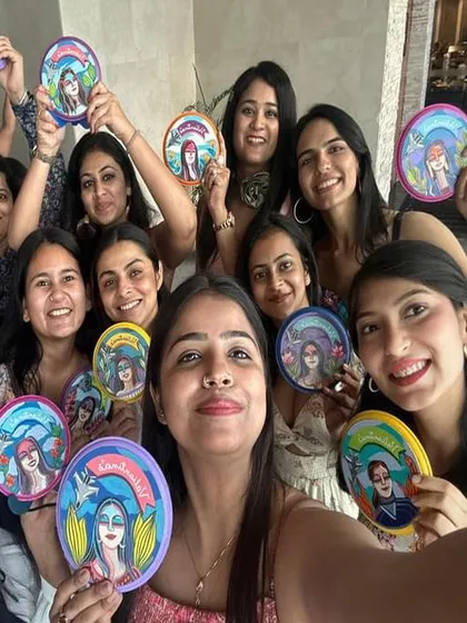 A team selfie with their custom-painted farewell gifts. It’s so rewarding to see the joy my art brings to people.