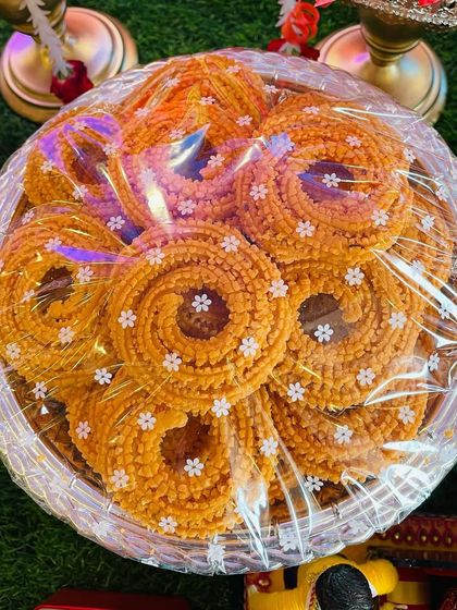 A plate full of crispy, homemade chakli (murukku), a favorite snack at any South Indian function. My plate decorations often include a mix of both sweet and savory items.